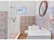 Updated bathroom featuring a walk-in shower, decorative tile, and a modern vanity at 509 Park Dr, Daytona Beach, FL 32114