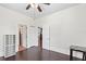 Light-filled room with hardwood floors, ceiling fan, and easy access to an adjacent bathroom at 509 Park Dr, Daytona Beach, FL 32114