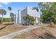 Charming home featuring a red door, stucco exterior and mature landscaping at 509 Park Dr, Daytona Beach, FL 32114