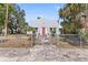 A charming home with a red door, a fenced yard, and mature landscaping at 509 Park Dr, Daytona Beach, FL 32114