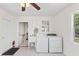 Well-lit laundry room with washer, dryer, utility sink, and an additional storage area at 509 Park Dr, Daytona Beach, FL 32114