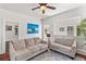 Bright living room with two sofas, hardwood flooring, and vintage column details at 509 Park Dr, Daytona Beach, FL 32114