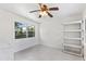 Bright, airy room with neutral tile flooring, white walls, ceiling fan, and a backyard view at 509 Park Dr, Daytona Beach, FL 32114