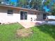 Backyard patio and outdoor seating area with a lush green lawn at 601 E Tall Pine Ter, Deland, FL 32724