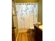 Bathroom featuring a toilet, vanity with sink, and a shower with a floral shower curtain at 601 E Tall Pine Ter, Deland, FL 32724