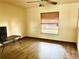 Bright bedroom featuring hardwood floors, ceiling fan, and a window with wood blinds at 601 E Tall Pine Ter, Deland, FL 32724