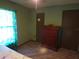 Bedroom boasting hardwood floors, a wardrobe, and a dresser at 601 E Tall Pine Ter, Deland, FL 32724