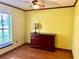 Bedroom featuring hardwood floors, a window, and a dresser at 601 E Tall Pine Ter, Deland, FL 32724