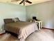 Bedroom featuring carpeted floors, a double bed, desk, and ceiling fan at 601 E Tall Pine Ter, Deland, FL 32724