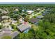 An aerial view capturing the lush landscape, a pool, and the serene lake in the vicinity at 69 Coquina Ridge Way, Ormond Beach, FL 32174