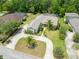 Aerial view of a home with a pool, landscaping, driveway and green lawn at 69 Coquina Ridge Way, Ormond Beach, FL 32174