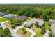 An aerial view of home with well-manicured lawn and an inviting screened-in pool area at 69 Coquina Ridge Way, Ormond Beach, FL 32174