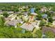 An aerial view highlighting the home, lush landscaping, and close proximity to a tranquil lake at 69 Coquina Ridge Way, Ormond Beach, FL 32174
