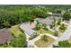 An aerial view of a well-kept home with lush landscaping and a screened-in pool area at 69 Coquina Ridge Way, Ormond Beach, FL 32174