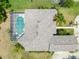 An aerial view of a home featuring an enclosed pool, landscaping, and a driveway at 69 Coquina Ridge Way, Ormond Beach, FL 32174