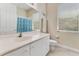 Bright bathroom featuring a vanity with drawers, a mirror, and a toilet with a shower and tub combination at 69 Coquina Ridge Way, Ormond Beach, FL 32174