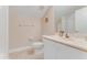 Clean bathroom featuring a vanity, mirror, and toilet, complemented by tiled flooring and natural light at 69 Coquina Ridge Way, Ormond Beach, FL 32174