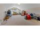 Spacious bonus room with high ceilings, arched windows, and plush carpeting, offering versatile living space at 69 Coquina Ridge Way, Ormond Beach, FL 32174