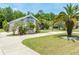 Beautiful single-Gathering home with palm trees, driveway, and mature landscaping at 69 Coquina Ridge Way, Ormond Beach, FL 32174