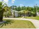 Beautiful single-story home featuring lush landscaping and a winding driveway at 69 Coquina Ridge Way, Ormond Beach, FL 32174