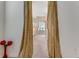 Hallway with patterned curtains, leads into bathroom with decorative glass block at 69 Coquina Ridge Way, Ormond Beach, FL 32174