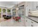 Cozy dining area with fireplace and views of the pool at 69 Coquina Ridge Way, Ormond Beach, FL 32174