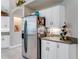 Kitchen features a stainless steel refrigerator with white cabinets and countertop at 69 Coquina Ridge Way, Ormond Beach, FL 32174