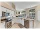 Bright kitchen with white cabinets, stainless steel appliances, and an open layout to dining area at 69 Coquina Ridge Way, Ormond Beach, FL 32174