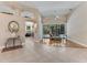 Open-concept living room with tile flooring, arches, and access to outdoor pool area at 69 Coquina Ridge Way, Ormond Beach, FL 32174