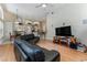 Spacious living room featuring an open floor plan, modern entertainment center, and wood floors at 69 Coquina Ridge Way, Ormond Beach, FL 32174