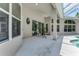 Relaxing covered patio area with a ceiling fan and views of the pool and surrounding landscaping at 69 Coquina Ridge Way, Ormond Beach, FL 32174