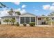 Screened-in back porch, a covered patio, with beautiful landscaping and trees surrounding the property at 8720 Sw 108Th Ln, Ocala, FL 34481
