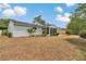 Exterior view of the home with a screened-in back porch, large yard, and mature landscaping at 8720 Sw 108Th Ln, Ocala, FL 34481