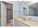 This blue bathroom features a large mirror with vanity and separate shower at 8720 Sw 108Th Ln, Ocala, FL 34481