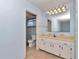 This blue bathroom features a large mirror with vanity and neutral tile at 8720 Sw 108Th Ln, Ocala, FL 34481