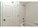 Clean bathroom with a shower over tub featuring tiled walls and floors at 8720 Sw 108Th Ln, Ocala, FL 34481