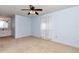 This light blue bedroom features neutral carpet, breezy white curtains, and an attached bathroom at 8720 Sw 108Th Ln, Ocala, FL 34481