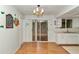 Bright dining area with hardwood floors, sliding glass doors to the patio, and white cabinets at 8720 Sw 108Th Ln, Ocala, FL 34481