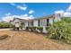 Charming one-story house with white siding, black shutters, and mature foliage at 8720 Sw 108Th Ln, Ocala, FL 34481