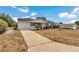 Inviting one-story home with an attached garage and well-kept front yard at 8720 Sw 108Th Ln, Ocala, FL 34481