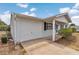 Attached one-car garage featuring white siding with a concrete driveway and front porch at 8720 Sw 108Th Ln, Ocala, FL 34481
