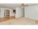 Open-concept living room showcasing a seamless blend of carpet and wood flooring, with easy access to the kitchen at 8720 Sw 108Th Ln, Ocala, FL 34481