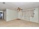 Inviting living room featuring neutral carpet, ceiling fan, and window with sheer curtains for natural light at 8720 Sw 108Th Ln, Ocala, FL 34481