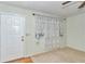 Cozy living room with carpet, window with curtains, and a white door at 8720 Sw 108Th Ln, Ocala, FL 34481
