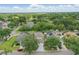 Aerial view of home surrounded by lush trees in quiet neighborhood with golf course in the distance at 1305 Rebecca Dr, Haines City, FL 33844