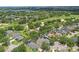 Beautiful aerial view of homes in golf course community featuring mature trees and well-maintained lawns at 1305 Rebecca Dr, Haines City, FL 33844