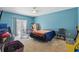 Bedroom with blue walls, neutral carpet, sliding door, and good natural light at 1305 Rebecca Dr, Haines City, FL 33844