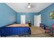 Bedroom featuring blue walls, neutral carpet, a window and a door leading to a bathroom at 1305 Rebecca Dr, Haines City, FL 33844