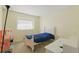 Bedroom with a window, desk, and neutral walls and carpet at 1305 Rebecca Dr, Haines City, FL 33844