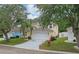 Charming two-story home with mature trees, front yard, two car garage and neutral color palette at 1305 Rebecca Dr, Haines City, FL 33844